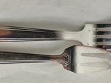 three forks that are sitting next to each other on a table