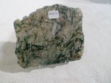 a rock with a tag on it sitting on a white surface