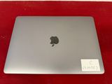 an apple macbook pro laptop is sitting on a red surface
