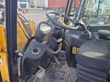 a close up view of the driver ' s seat of a construction vehicle