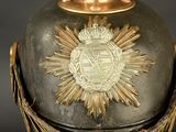 a large metal vase with a gold star on top of it