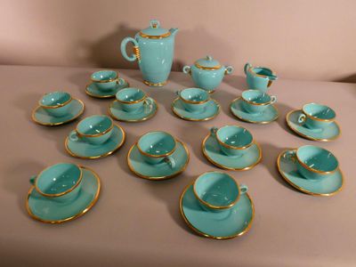 many tea cups and saucers sitting on a table