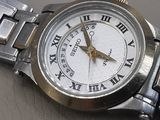 a close up of a wrist watch with roman numerals on it