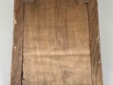 an old wooden plaque mounted on a wall with a white background