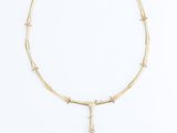 a gold plated necklace with a cross and a gold chain