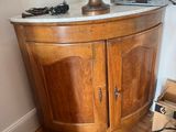 a wooden cabinet with a marble bust on top of it