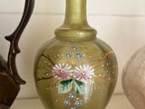 three vases sitting on a shelf next to each other