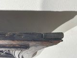 a wooden shelf with a clock on top of it