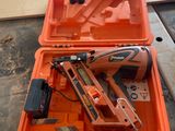 an orange tool box with a stapler and nail gun in it