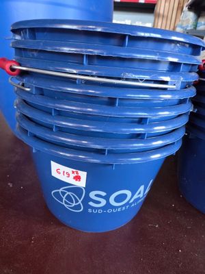 several blue buckets are stacked on top of each other on a table