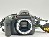 a black camera with a yellow strap attached to it