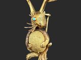 an image of a gold rabbit with a blue eye sitting on top of a tree branch