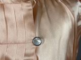 a close up of a mannequin dress with buttons on it