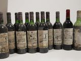 several bottles of wine are lined up in a row on a table