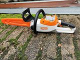 a close up of a chainsaw sitting on the ground on the ground