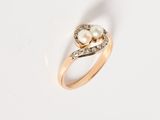 an image of a pearl and diamond ring on a white surface