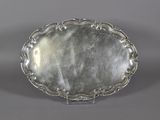 a silver plate with a decorative design on the rim