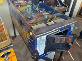 two pinball machines sitting next to each other on the floor