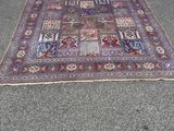 rug on the ground in front of a garage with a door open