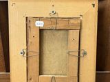 an old picture frame with a picture of a cat hanging on it