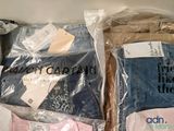 two bags of clothing that are wrapped in plastic