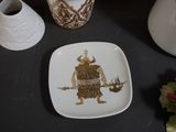 a white plate with a picture of a warrior on it