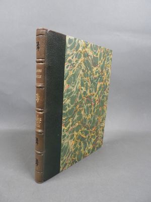 an old book sitting on top of a table next to a gray background