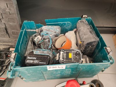 a blue box with tools in it sitting on the floor