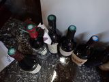 several bottles of wine are lined up on a counter top