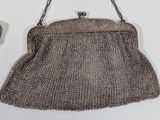 two purses that are hanging on a wall