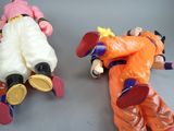 two figurines of two different characters laying on a table
