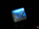 a close up of a blue stone on a black surface