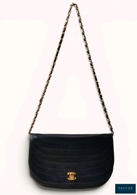 a black purse with a gold chain hanging from it