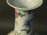 a white vase with a floral design on it