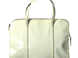 a white handbag with a zipper on the front