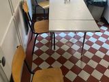 several chairs and a table in a small room with a red and white checkered floor