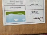 a cardboard box with a sticker on it sitting on the back of a truck