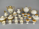 a lot of white and gold items on the table