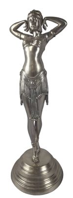 silver statue of a woman with her hands on her head