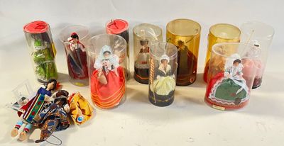 a lot of different glass vases with dolls inside of them