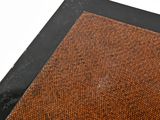 a brown area rug with a black border on a white background