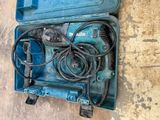 a blue tool in a blue case on the ground