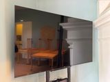a flat screen tv mounted on a wall in a living room