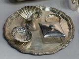 a silver tray with silver items on it on a table