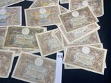 several different types of currency are displayed on a black surface