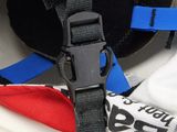 a helmet with a blue strap on it sitting on top of a table
