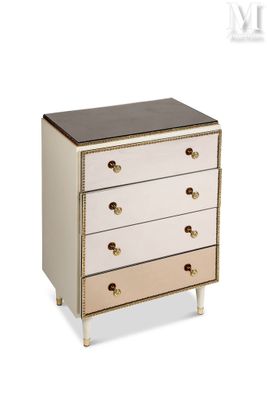a white and gold chest of drawers with a black top