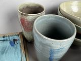 many different bowls and bowls sitting on a table