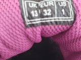 someone is holding a pink teddy bear with a black tag