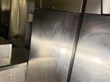 a stainless steel refrigerator in a kitchen next to a sink